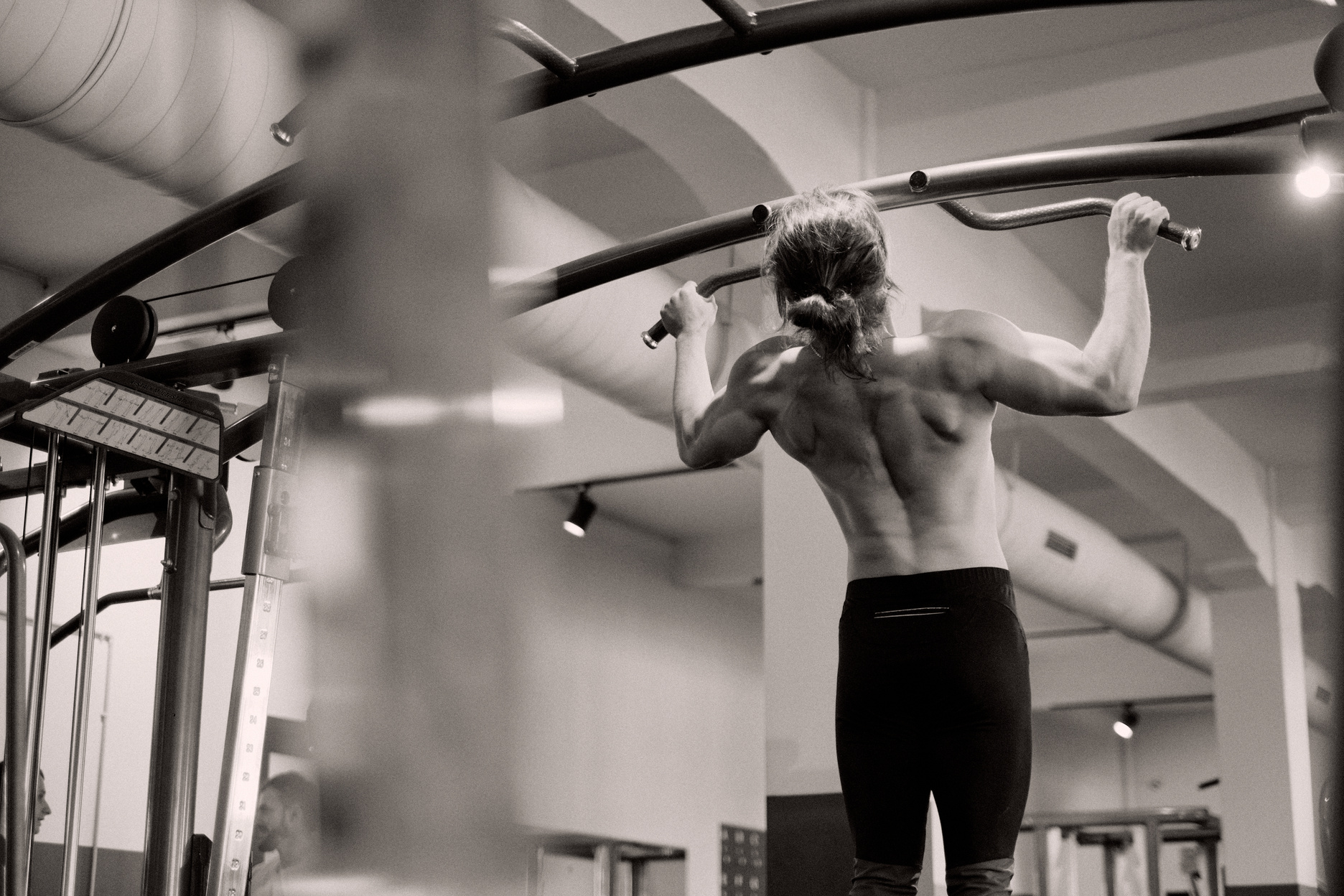 Topless Man Exercising at a Gym